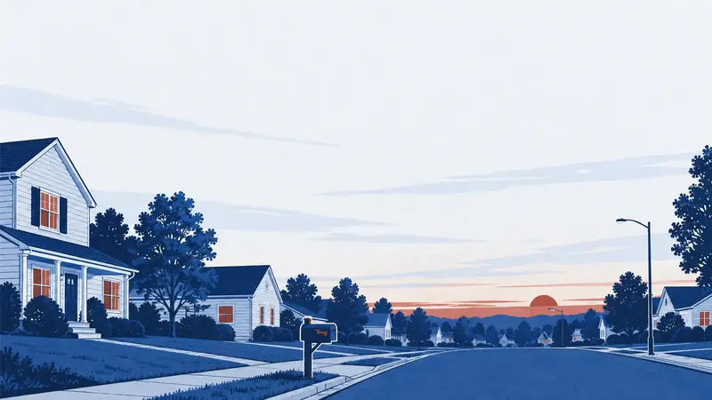 A quiet suburban street of clapboard houses with a curbside mailbox at dusk.
